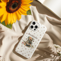 Neutral floral book lover mom iPhone case with stacked books design placed on soft beige fabric with warm sunlight aesthetic