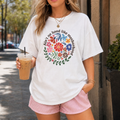White t shirt featuring colorful floral wreath design and Ain't No Hood Like Motherhood quote for moms.