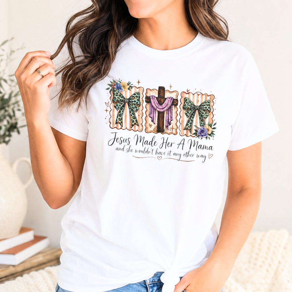 Christian mama t shirt featuring Jesus Made Her A Mama quote with floral bows and cross design on white shirt.