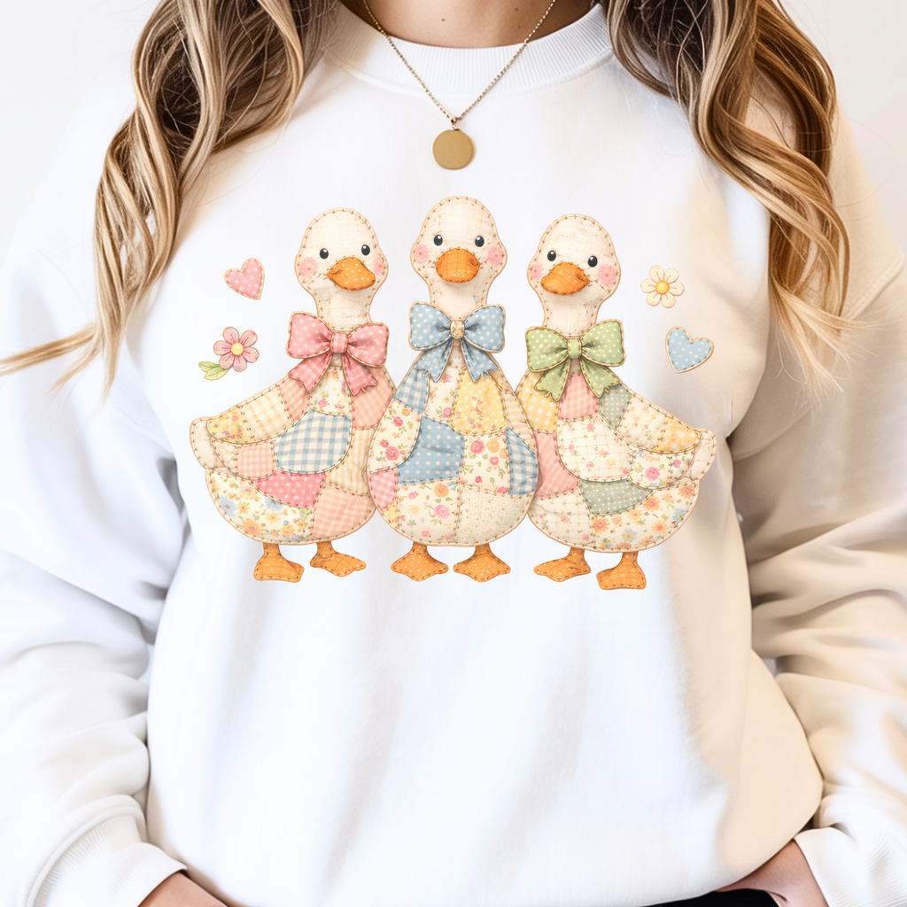 Close up of cute duck faux patchwork design with bows and floral details on aesthetic sweatshirt