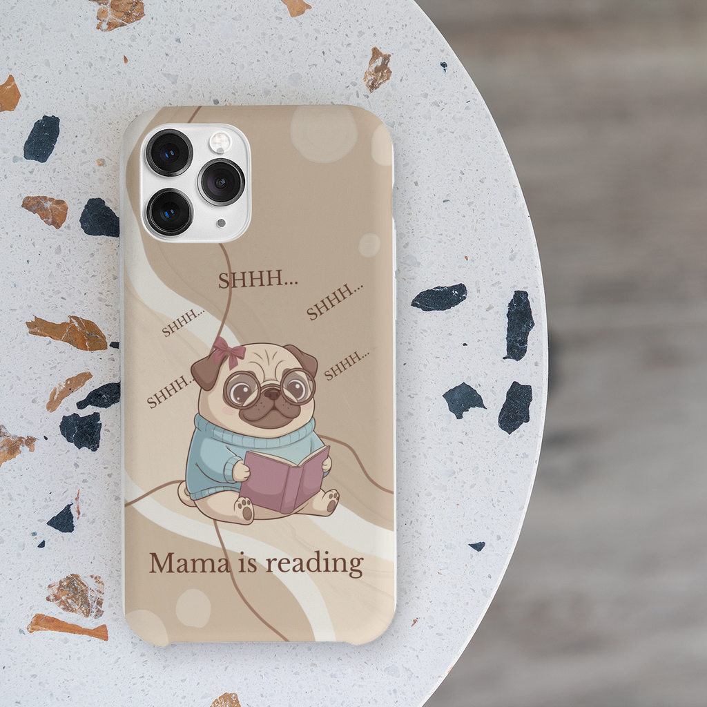 Flat lay of beige iPhone case with adorable pug reading book illustration for bookish moms
