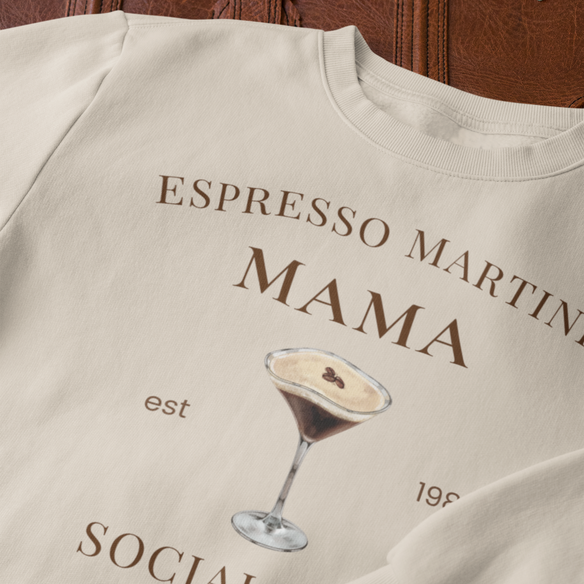 Close up of Espresso Martini Mama cocktail graphic on sand sweatshirt