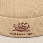 Close-up embroidery detail of “Future Bookish Mama” text and book design on beige knit beanie
