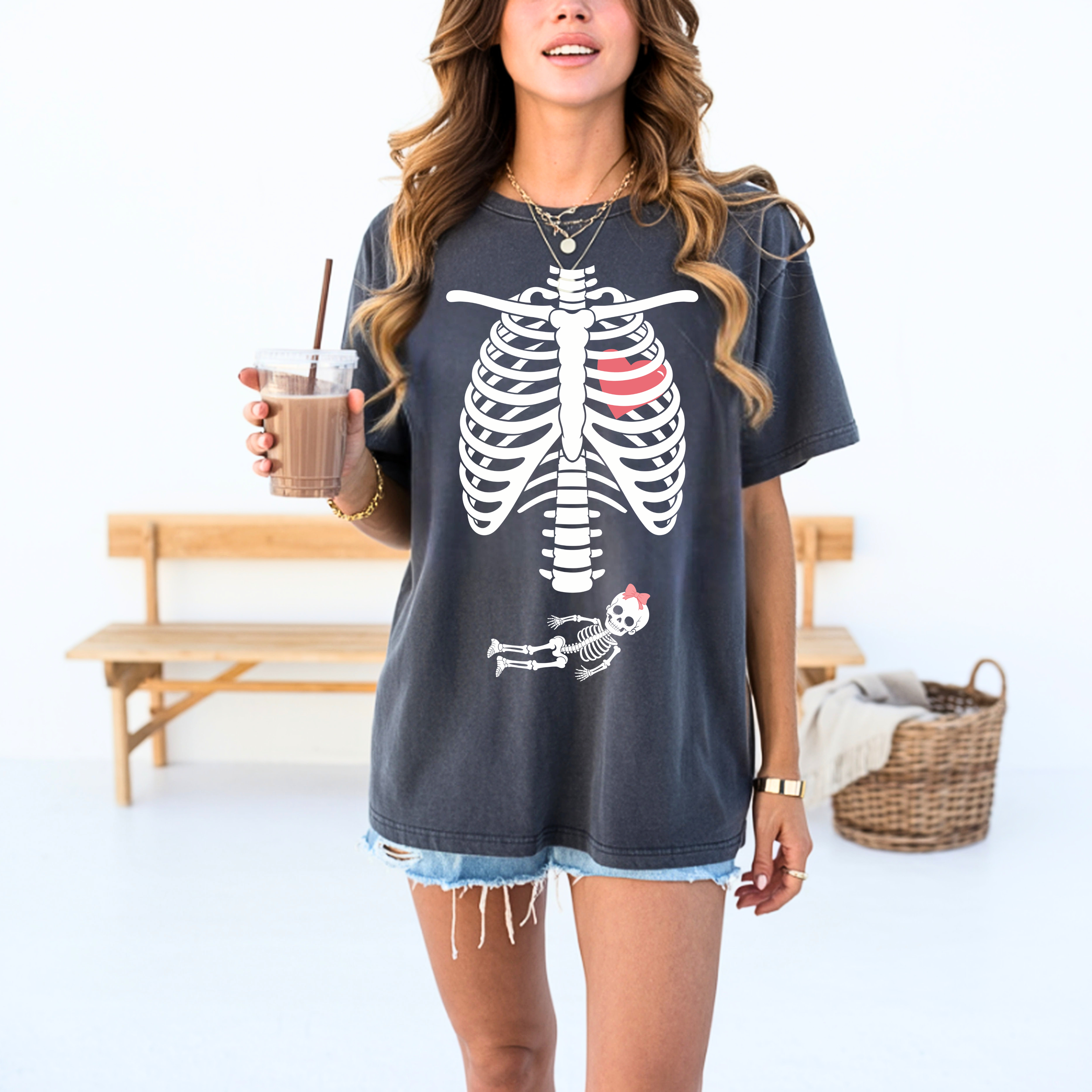 Woman wearing Halloween pregnancy reveal skeleton baby bump shirt