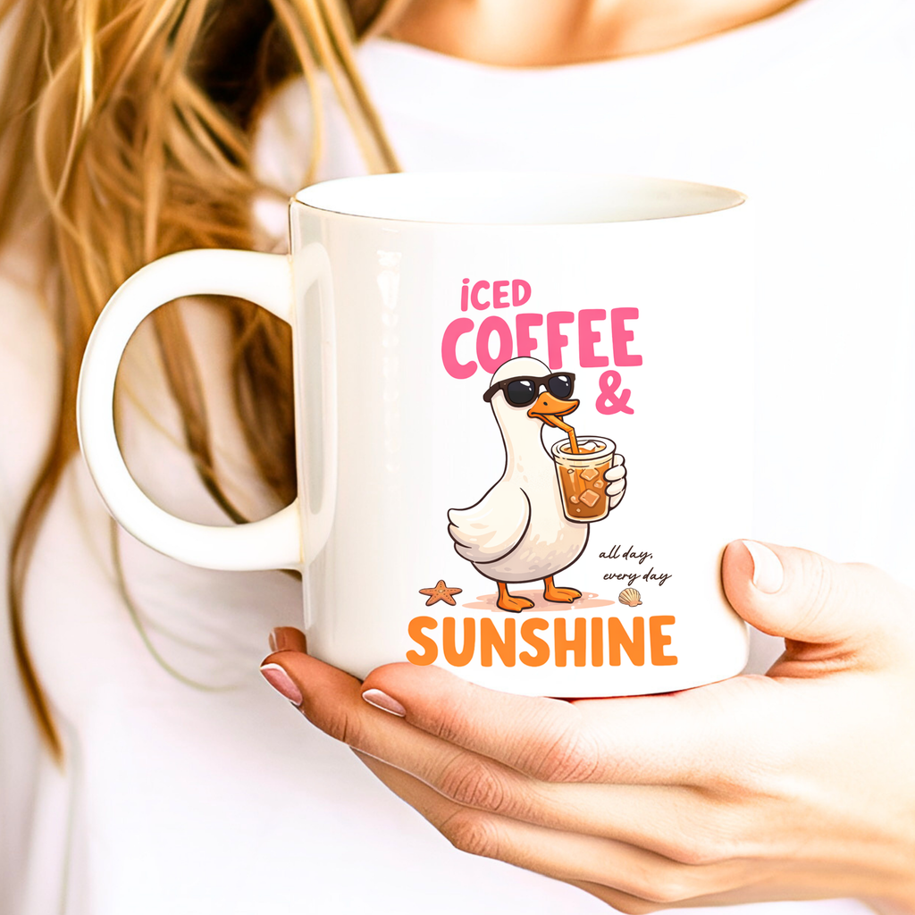 Woman holding iced coffee and sunshine mug featuring cute duck coffee lover design