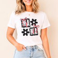 Woman wearing white mama bow floral graphic t shirt featuring pink ribbon bows and black flower design.