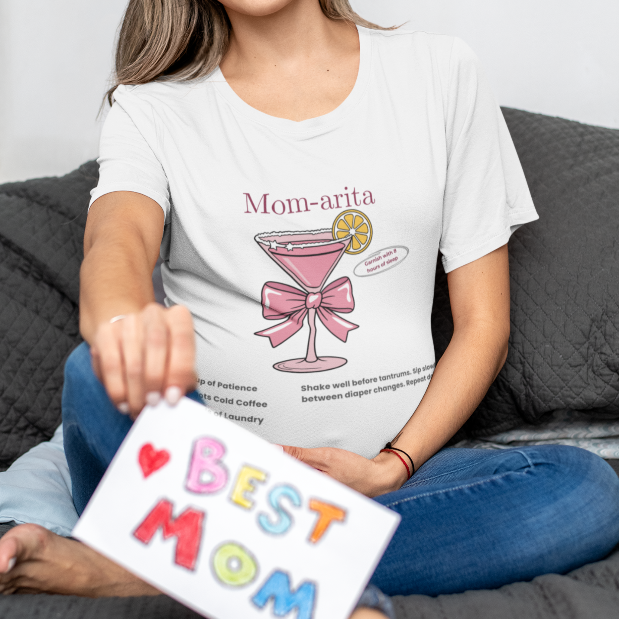 Woman sitting casually wearing Mom-arita mom life graphic t-shirt