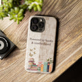 Motherhood themed phone case with books illustration placed on wooden table, perfect gift for reading moms