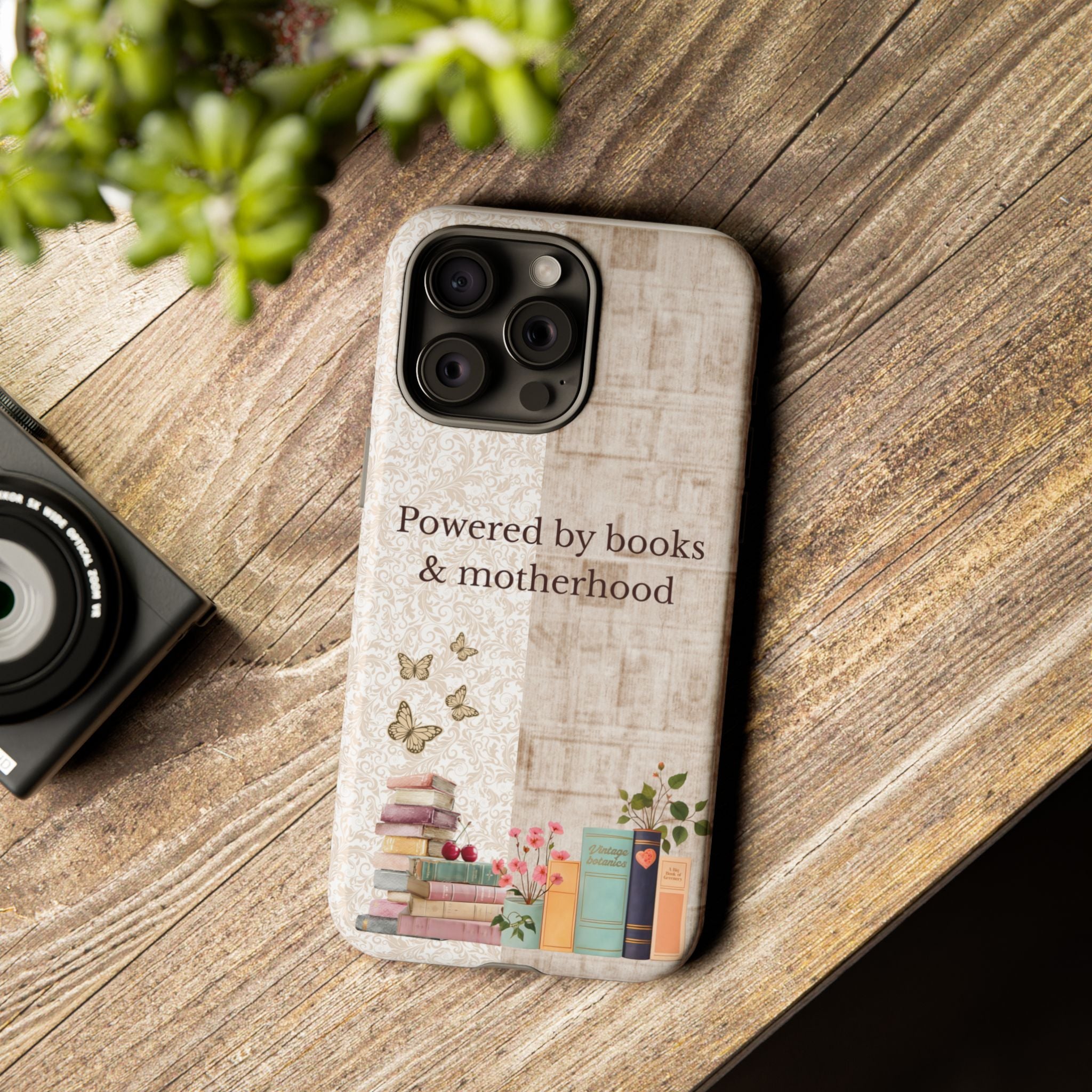 Motherhood themed phone case with books illustration placed on wooden table, perfect gift for reading moms