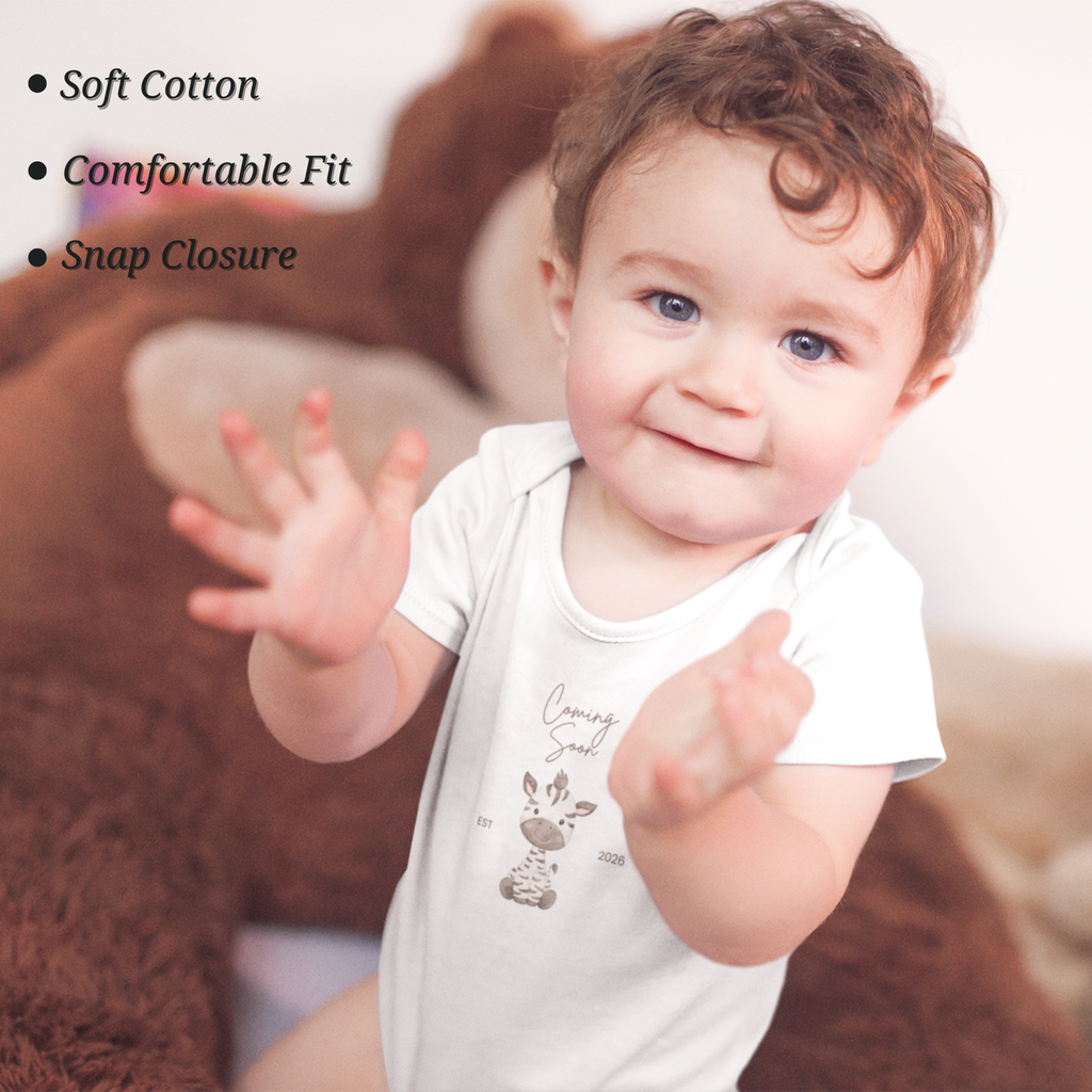 newborn baby wearing coming soon giraffe onesie for pregnancy announcement