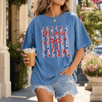 Woman wearing Blue Jean Comfort Colors Patriotic Mama t-shirt with patriotic floral bow graphic