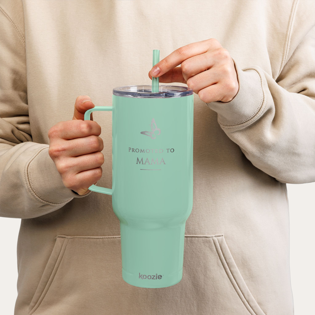 Woman holding mint green Promoted to Mama 40oz tumbler, cute pregnancy reveal gift idea for expecting mother