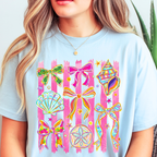 Woman wearing chambray blue Seashells and Ribbons summer graphic tee with coastal artwork