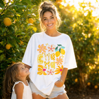 Woman wearing Summer Mama floral graphic tee outdoors, stylish summer mom outfit for vacations, coffee runs, and everyday wear.