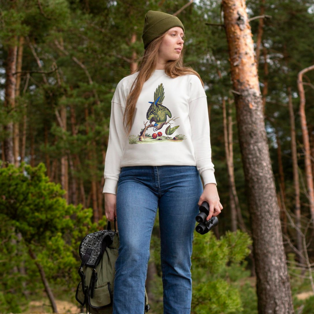 Woman wearing nature bird sweatshirt styled with jeans, casual cozy outfit aesthetic fall clothing